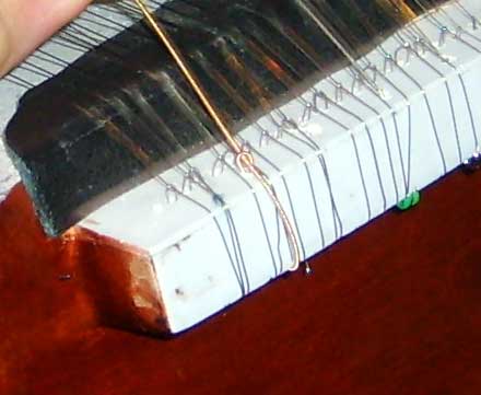Mounting a dilruba string (close up)
