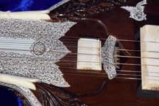 Sympathetic bridge and sound-hole